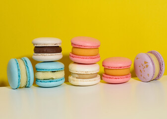 baked round macarons on a yellow background, delicious dessert