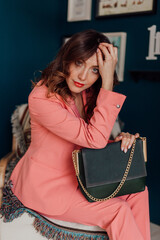 Multi-colored women's bags, photo in a colored interior and in the hands and shoulder of the girl. natural light