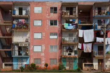 Laundry hangs on clothes lines on balconies of a run down high-rise apartment building