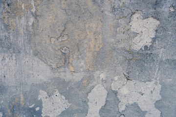 The background is made of rugged, gray blue colored plaster walls.