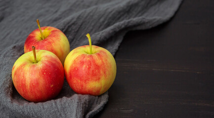 Red apple on a black wooden table.