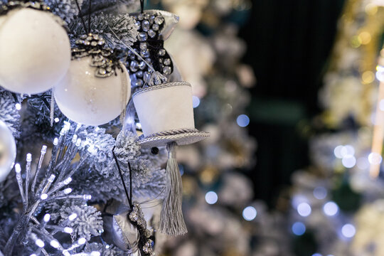 Close Up Of Holidays Location With Toys And Garlands On Blue White Christmas Tree