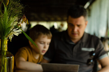 father and son eat in a beautiful cafe on Father's Day