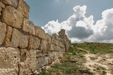 Fototapeta na wymiar Ruins of an ancient fortress. An old wall of large stones. The remains of a former civilization.