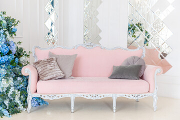 Beautiful luxury classic clean interior living room in white color with pink sofa flower...