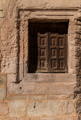 Fototapeta na wymiar Wooden window on stone wall in Sepulveda, Spain