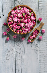 Basket and scoop with tea rose buds