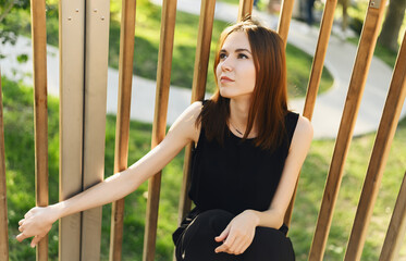 Portrait of beautiful young woman in the park.