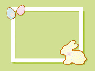 A frame on a yellow background with Easter gingerbread in the shape of an egg and a rabbit.
