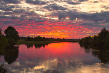 beautiful red pink dawn by the river