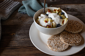 Bowl with breakfast on wooden table 