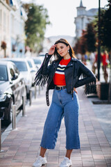 Young trendy woman in leather jacket outside