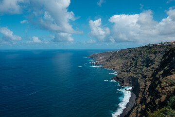 Obraz premium Coastal landscape aerial - ocean horizon and Island shore with beach and blue sky background, Tenerife