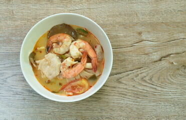 boiled river shrimp and bass fish with mushroom in Thai spicy soup or tom yum kung on bowl