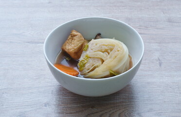 boiled cabbage with carrot and tofu topping slice mushroom vegetarian soup on bowl