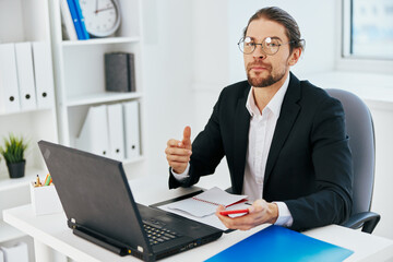 man in a suit work in the office in front of a laptop executive