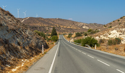The highway with left-hand traffic leading to the mountain massif of the island of Cyprus