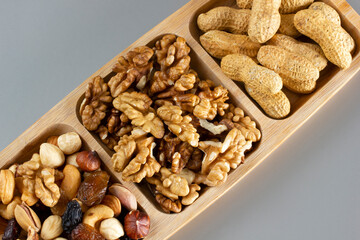 Mixed nuts in a bamboo plate. Healthy food concept.