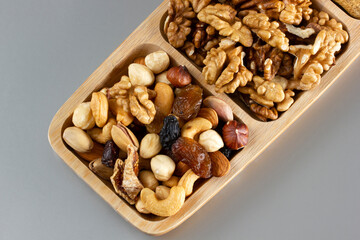  Mixed nuts in a bamboo plate. Healthy food concept.