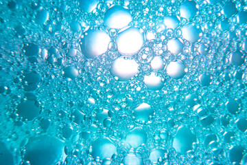 Water drops mixed with detergent on a color background