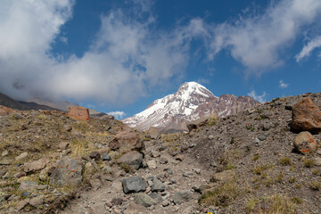 A cloudless view on Mount Kazbeg in Caucasus, Georgia. There slopes are barren and stony below the snow-capped peak and the Gergeti Glacier. Tranquillity. Natural remedy. Massive glacier foot