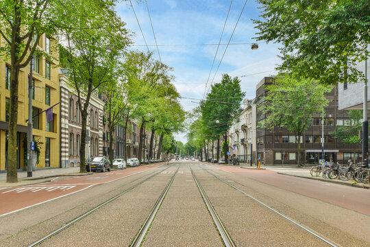 Tram rails on urban road between building facades