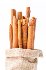 Cinnamon sticks in sag bag on white