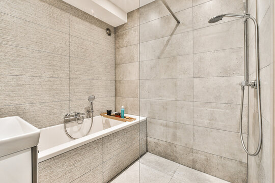 Modern bathroom interior with bath and ceramic walls