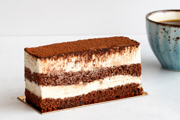 tiramisu cake on a white background. Along with a cup of coffee