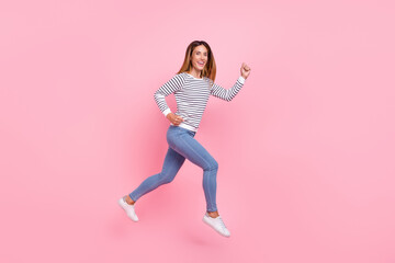 Fototapeta na wymiar Full lenght profile photo of mature nice brown hairdo lady run wear shirt jeans sneakers isolated on pink background