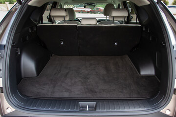 Huge, clean and empty car trunk in interior of a modern compact suv. Rear view of a SUV car with...