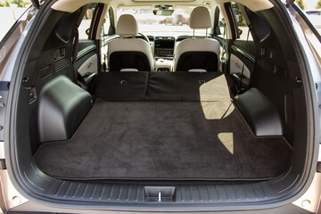 Huge, clean and empty car trunk of a modern compact suv. Rear view of a SUV car with open trunk and...