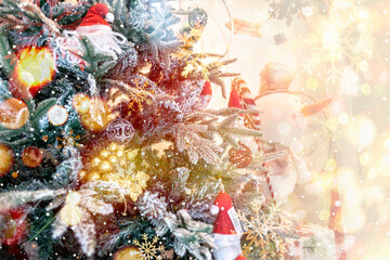 Close up of a christmas tree ornaments baubles with some Santa Clauses and golden bokeh lights....