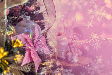 Close up of a christmas tree ornaments baubles pink flowers snow flakes bokeh lights. Christmas card background wallpaper celebration concept