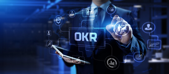 Fototapeta na wymiar OKR Objectives key results. Businessman pressing button on screen.