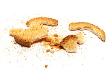 Broken rusks pile, broken pieces with crumbs isolated on white  