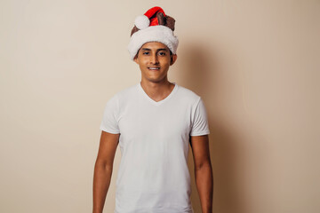 portrait of an adult man with christmas hat looking at camera