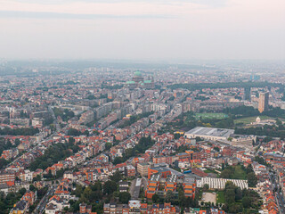 Fototapeta na wymiar Aerial panorama view of Brussels-Capital Region and suburban area in the foreground. View from Ganshoren municipality during grey sunset