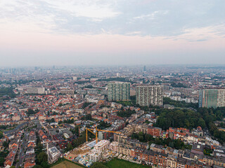 Fototapeta na wymiar Aerial panorama view of Brussels-Capital Region and suburban area in the foreground. View from Ganshoren municipality during grey sunset