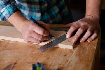Joinery. Close-up workers. The carpenter measures with a ruler and draws with a pencil. Tree....