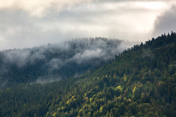 Clouds and fog over mountains and hills after rain in the Vosges, France