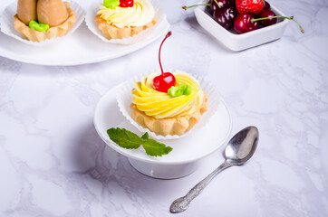Tartlet cake filled with fruit cream on a plate