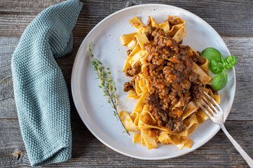 Duck ragout with tagliatelle on a plate - obrazy, fototapety, plakaty