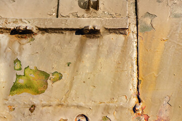 Photo of old and rusty yellow colored military vehicle armored surface plate.