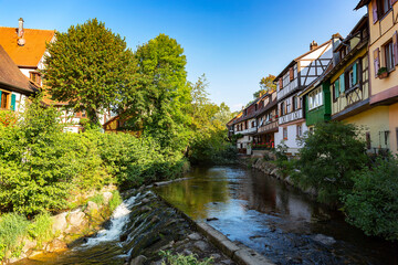 Fototapeta na wymiar River with ancient colourful buildings in old town of Kaysersberg, Alsace, France