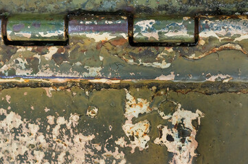 Photo of old and rusty military vehicle armored surface plate with hinge.