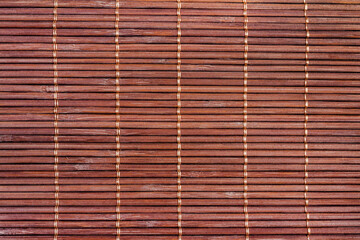 Photo texture of brown colored bamboo mat.