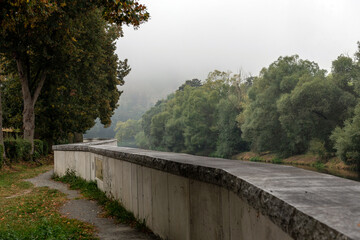 flood barrier along the river and trees around