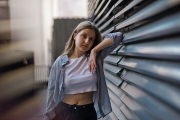 feeling of joy. Young student with some folders poses on university campus