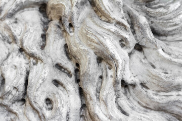 Close-up photo texture of worn marble statue hair pattern.